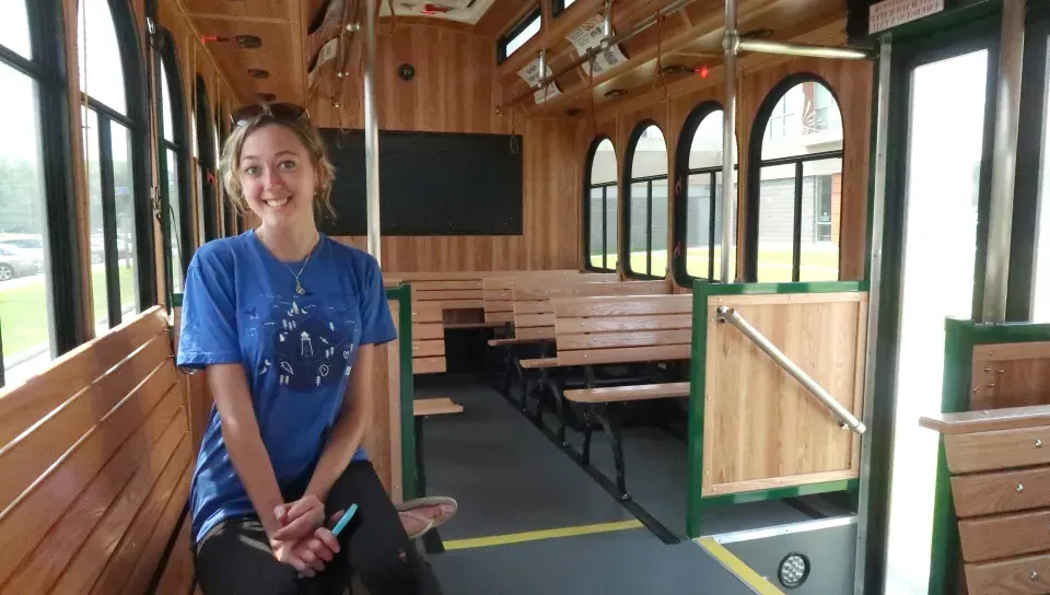 a U N E student rides the trolley